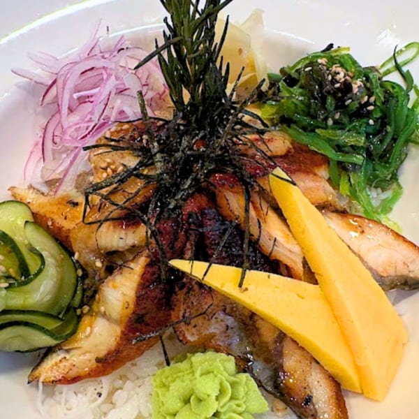 Sushi Hiro's unagi donburi with grilled eel, tamago, seaweed salad, red onions, and cucumber.