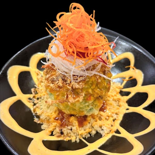 Sushi Hiro's deep-fried sushi ball with shredded carrots, daikon, sauce, and tempura flakes.